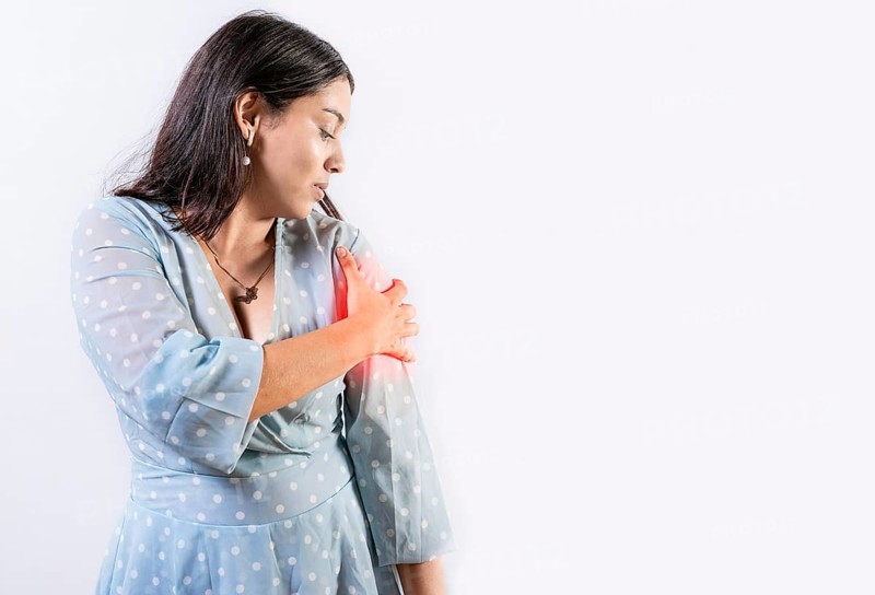 Woman with pain touching shoulder isolated. People with shoulder pain and tension on white background