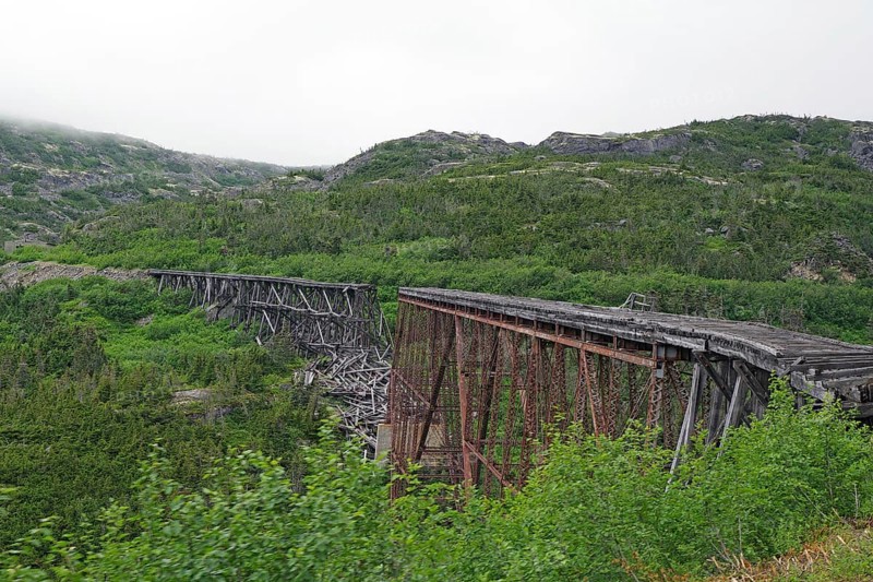 Remains of an old wooden railway bridge, wilderness, mountain landscape, White Pass Railway, Skagway, Alaska, USA, North America