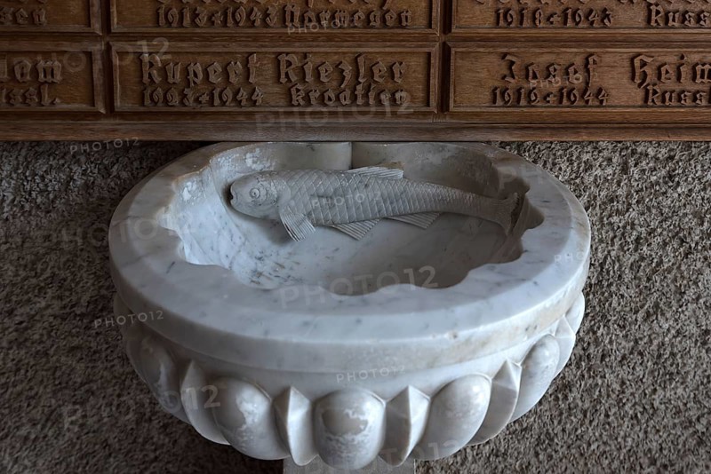 Marble holy water font with fish sculpture, porch of the Maria Opferung parish church, Riezlern, Kleinwalsertal, Austria, Europe