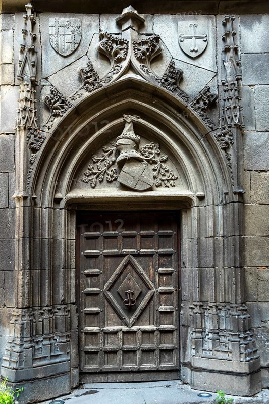 Chateaugay. Carved door in the courtyard of the castle. Puy de Dome department. Auvergne Rhone Alpes. France