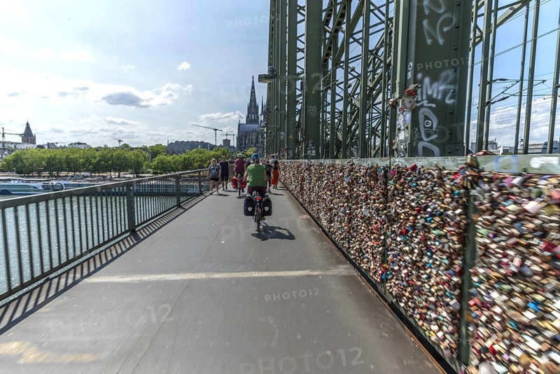 Cycling from a first-person perspective on a shared footpath and cycle path over the Hohenzollern Bridge in Cologne, North Rhine-Westphalia, Germany, Europe