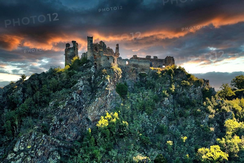 Village of Saint-Remy-de-Biot, the medieval castle in ruins of Chateau Rocher at sunset (15th century) overlooks the soul valley, Puy de Dome, Auvergne, France, Europe