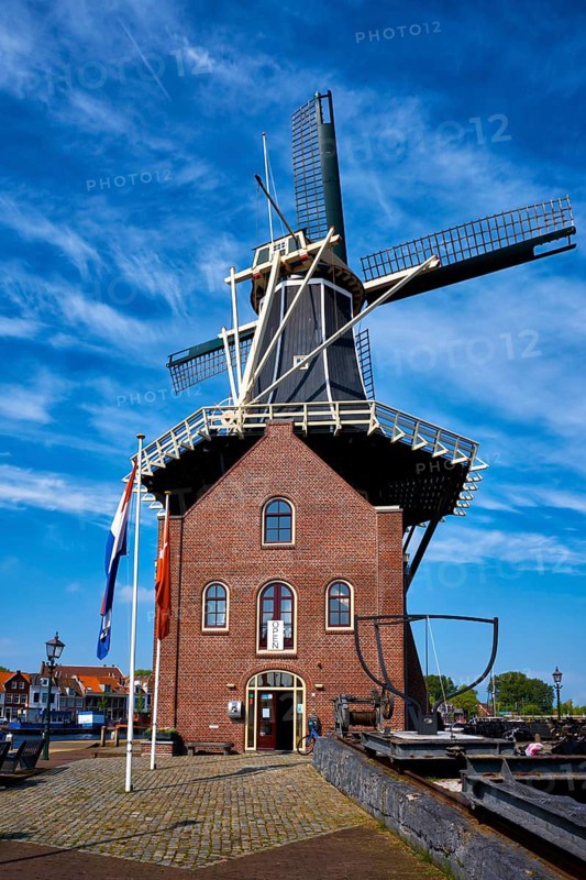 HAARLEM, NETHERLANDS, MAY 6, 2017: Windmill De Adriaan on Spaarne river. Harlem, Netherlands. The original windmill dates from (1779) and is a distinctive part of the skyline of Haarlem