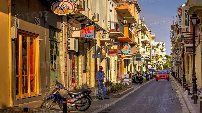 Venetian old town, old town street, moped, man, red car, lanterns, shop signs, colourful houses, cobbled street, morning light, Rethimnon, central Crete, island of Crete, Greece, Europe