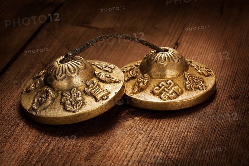 Tibetan Buddhist tingsha cymbals on wooden background