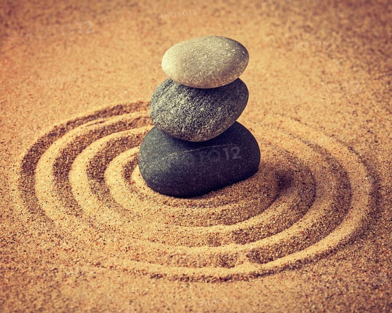 Vintage retro effect filtered hipster style image of Japanese Zen stone garden, relaxation, meditation, simplicity and balance concept, pebbles and raked sand tranquil calm scene