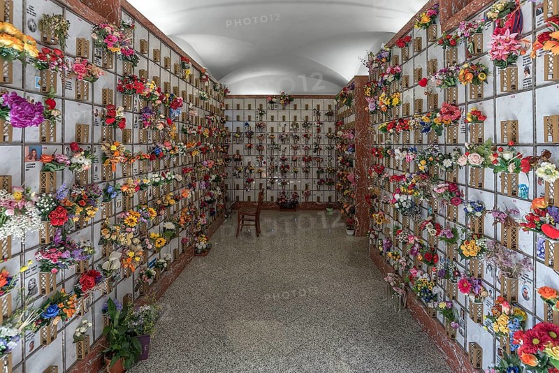 Graves with floral decorations in a hall at the Monumental Cemetery, Cimitero monumentale di Staglieno), Genoa, Italy, Europe