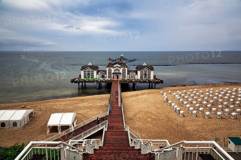 Wooden bridge sky ladder leading down to the pier Sellin, single tourists, rainy weather at the Baltic Sea, empty beach chairs, view from above, long exposure, Baltic resort Sellin, island Rügen, Mecklenburg-Western Pomerania, Germany, Europe