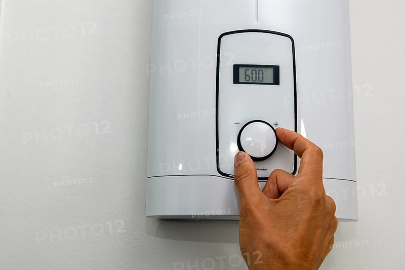 Instantaneous water heater for hot water shower for shower washbasin bidet is set with very high temperature of 60 degrees Celsius for hot water for killing bacteria legionella with high consumption of energy power consumption power consumption, Germany, Europe