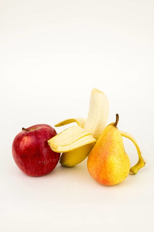 Half peeled banana with apple and pear, studio shot, white background, healthy food