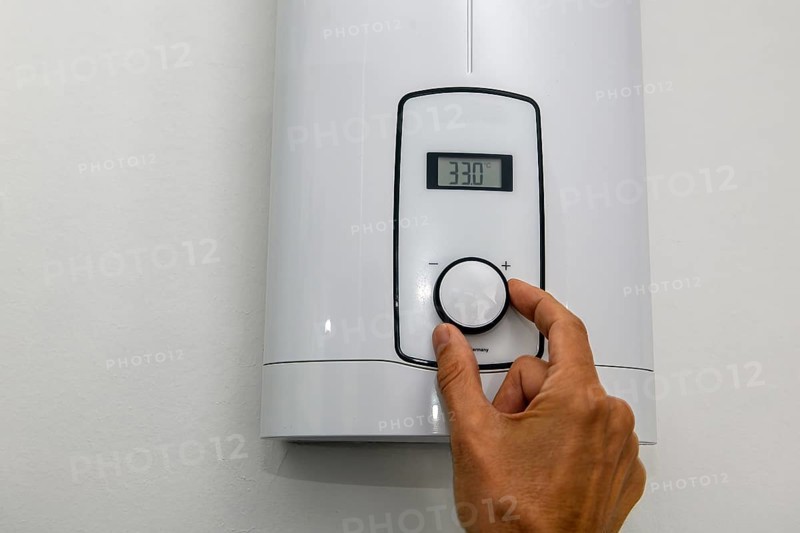 Instantaneous water heater for hot water Shower for showering Washbasin Bidet is set to low-energy level 33 degrees Celsius for saving energy Electricity energy saving Electricity saving, Germany, Europe