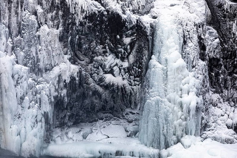 Iced and snow-covered rock face, at Godafoss waterfall, Northern Iceland Eyestra, Iceland, Europe