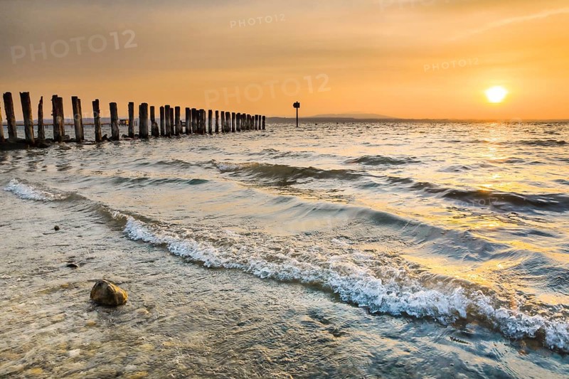 Golden sunrise on the shore of Lake Constance with jetty near Altnau in the canton of Thurgau, Switzerland, Europe