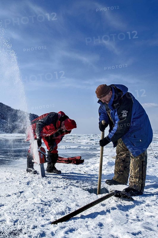 Digging a hole in the ice for scuba diving, Lake Baikal, Olkhon Island, Pribaikalsky National Park, Irkutsk Province, Siberia, Russia, Europe