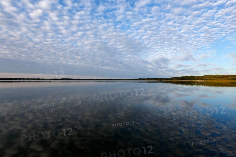 Cloud formation with reflection in the water over a lake in Mecklenburg, Müritz National Park, Mecklenburg-Vorpommern, Germany, Europe