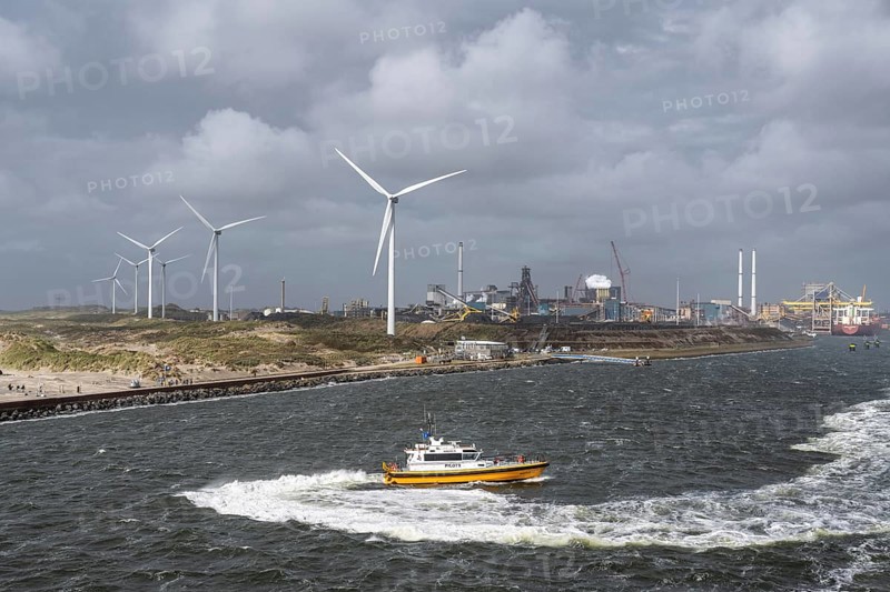 Pilot ship (Aquila) Pilots operating in the North Sea, with wind turbines and the steelworks of Tata Steel, Velsen-Noord, North Holland, Netherlands, behind