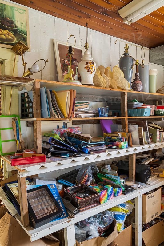 Paintings, lamps and stationary items for sale inside second hand goods and chattels store, Quebec, Canada, North America