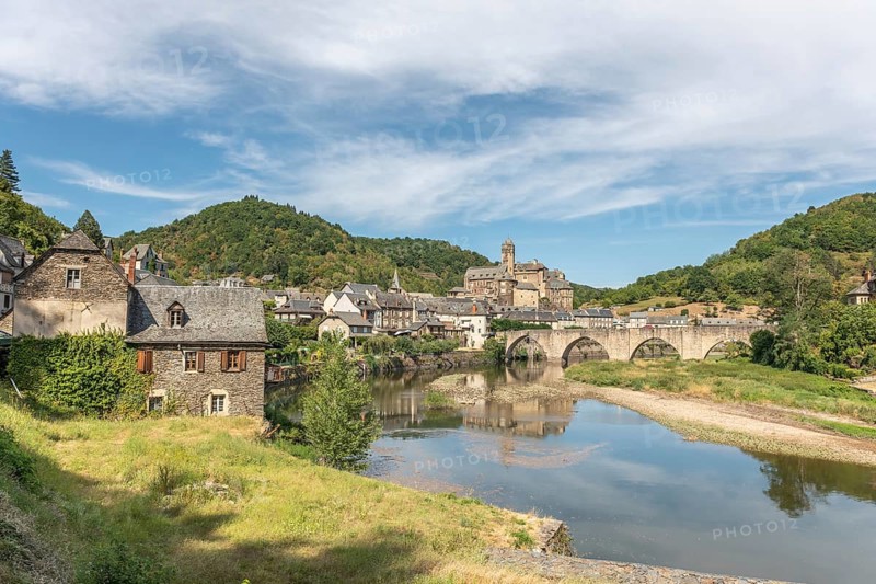 Medieval bridge over Lot with castle in village of Estaing. Aveyron, France, Europe
