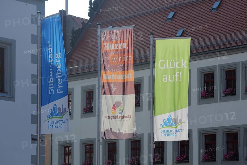 Three flags with inscription Silberstadt UNESCO at the town hall, symbol, mining, Obermarkt, Freiberg, Saxony, Germany, Europe