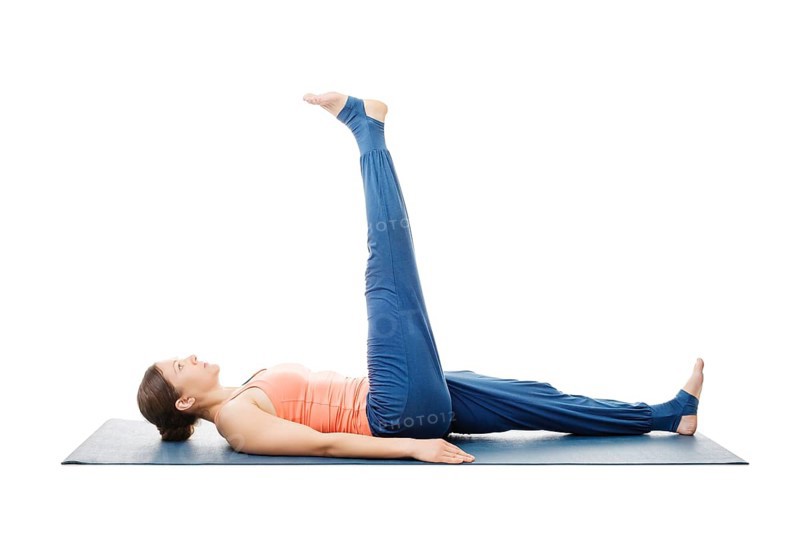 Woman doing yoga asana Uttanpadasana, lying down straight leg raise pose posture isolated on white background