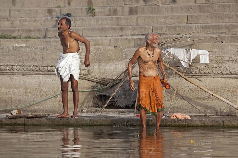 Indian men washing at a ghat along the holy Ganges river, Varanasi, Uttar Pradesh, India, Asia