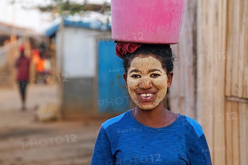 Malagasy woman with sun protection mask made from Musiro root at Begidro, Ankiliroroka, Belo sur Tsiribihina, Menabe, Central Highlands, Madagascar, Africa