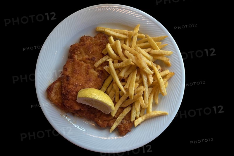 Wiener Schnitzel with french fries on a black background, Franconia, Bavaria, Germany, Europe