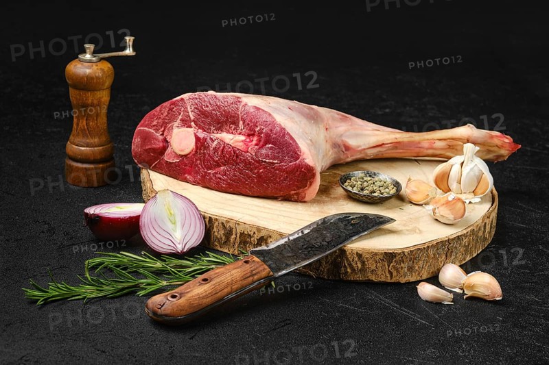 Raw fresh lamb short cut leg, sirloin off on wooden stump