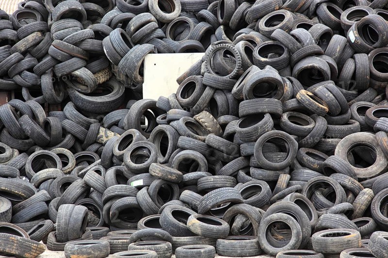 Old car tyres lie on stockpiles for recycling