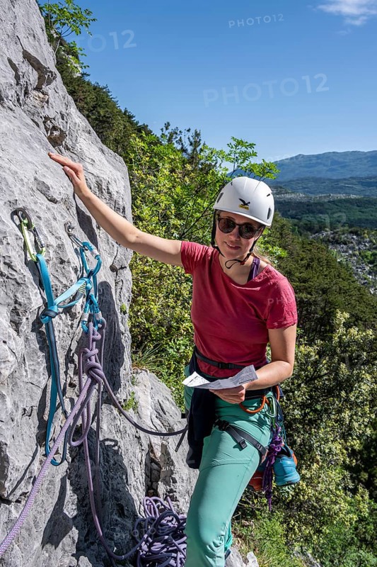 Climber on the rope looking at the topo, multi-pitch climbing, Via la Bellezza della Venere, Garda Mountains, Arco, Trentino-Alto Adige, Italy, Europe