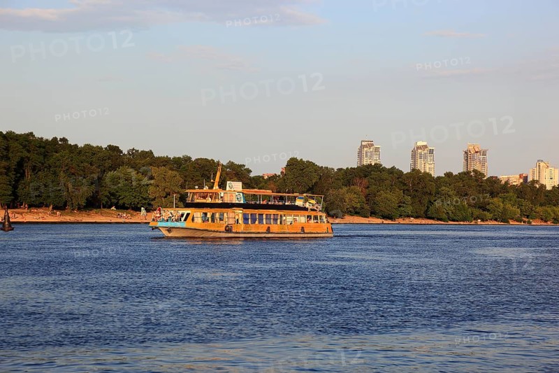 Excursion boat on the river Dnepr and skyscrapers in the background, Kiev, Ukraine, Europe