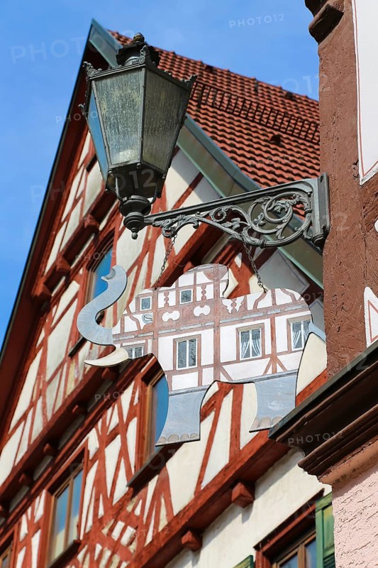 Lamp, old lamp, painted tin elephant, sign, stamped part, shop sign, inn sign, half-timbered houses, Wiesensteig, Filstal, Baden-Württemberg, Germany, Europe