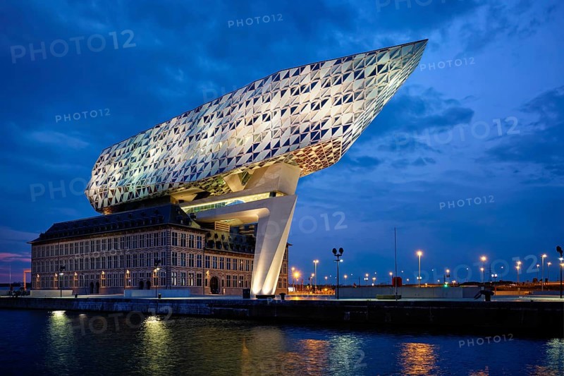 ANTWERP, BELGIUM, MAY 27, 2018: Antwerp port administration headquarters, designed by famous iranian architect Zaha Hadid, Antwerpen, Belgium illuminated at night