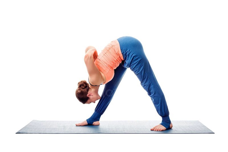Woman doing Ashtanga Vinyasa Yoga asana Parsvottanasana, intense side stretch pose isolated on white background