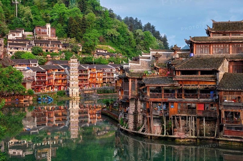 Chinese tourist attraction destination, Feng Huang Ancient Town (Phoenix Ancient Town) on Tuo Jiang River with Wanming Pagoda tower on sunset. Hunan Province, China, Asia