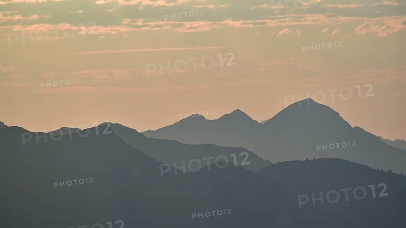 Silhouette of the Sonntagshorn, highest mountain of the Chiemgau Alps, in the backlight, Bavaria, Germany, Europe