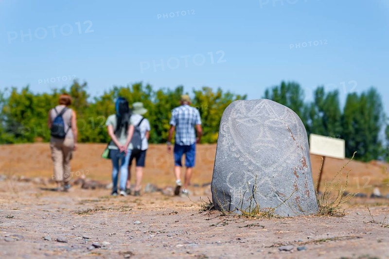 Tourists, Balbals, historical gravestones in the shape of human faces, near Tokmok, Chuy, Kyrgyzstan, Asia