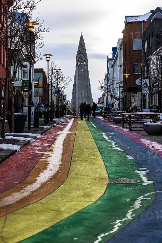 Shopping street Skolavördustigur, painted in the colours of the rainbow, lightly covered with snow, Hallgrims Church in the back, Reykjavik, Reykjanes Peninsula, Sudurnes, Iceland, Europe
