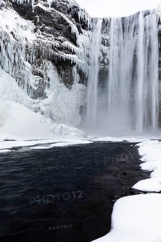 Skogafoss waterfall, snowy and icy rock face, Sudurland, Iceland, Europe