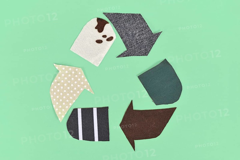 Recycling arrow symbol made from old textile pieces