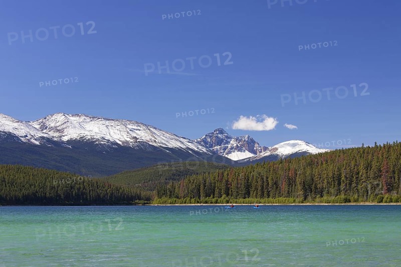 Two kayakers kayaking on Pyramid Lake at the foot of Pyramid Mountain in the Jasper National Park, Alberta, Canada, North America