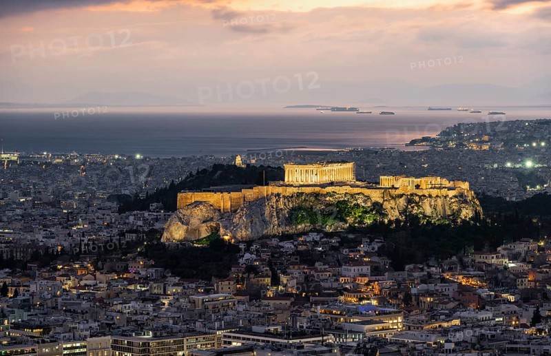 View over the sea of houses of Athens, illuminated Parthenon temple on the Acropolis, from Mount Lycabettus, Athens, Greece, Europe