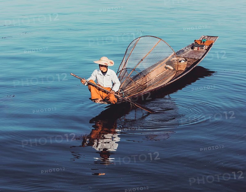 Myanmar travel attraction, Traditional Burmese fisherman at Inle lake, Myanmar famous for their distinctive one legged rowing style. Vintage filtered retro effect hipster style image