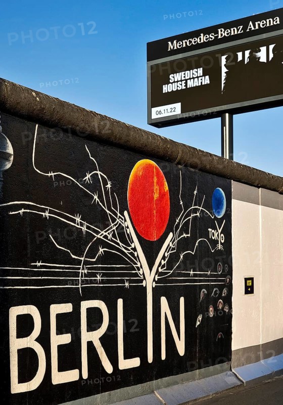 Mural entitled Berlyn on a remnant of the Berlin Wall, artist Gerhard Lahr, with advertising, East Side Gallery, Friedrichshain, Berlin, Germany, Europe