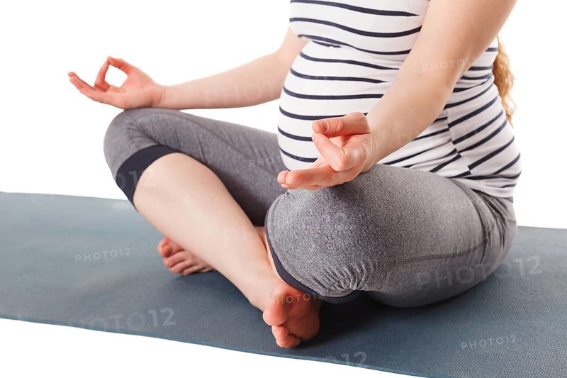 Pregnancy yoga exercise, pregnant woman doing asana Sukhasana with chin mudra easy yoga pose isolated on white background