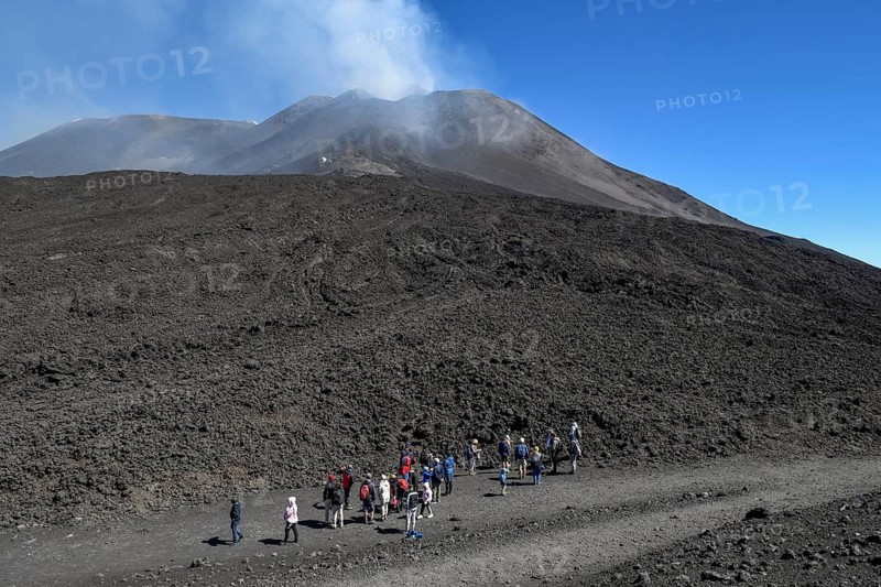 Hikers in the crater landscape of the volcano Etna, summit region, province of Catania, Sicily, Italy, Europe