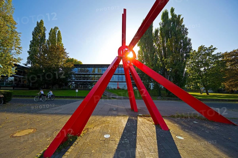 Bright red sculpture made of steel profiles L'Allumé by Mark di Suvero in front of the Bundeshaus on the Rhine, Bonn, North Rhine-Westphalia, Germany, Europe