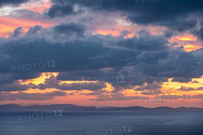 Dramatic cloudy sky at sunrise over the sea, Aegean Sea, Syros, Cyclades, Greece, Europe