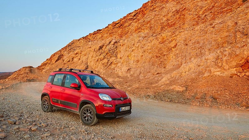 Morning light, red Fiat Panda 4x4, driving track, reddish rock, Gramvoussa peninsula, Pirate Bay, Balos, Tigani, West Crete, island of Crete, Greece, Europe