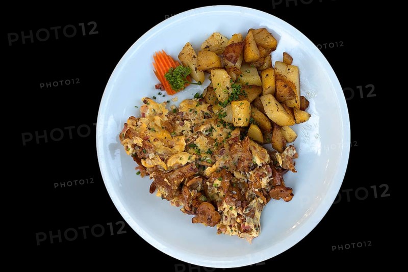 Fried potato with scrambled eggs on black background, Bavaria, Germany, Europe